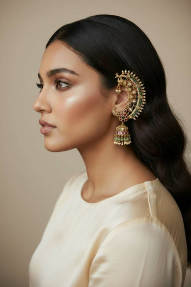 Close-up of Inaury Maharani Ear Cuff with Jhumka Pearl White on model — crescent-shaped ear cuff with peacock motif and jhumka drop detail