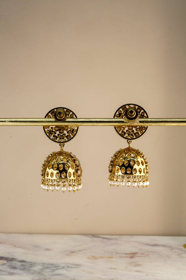 Back view of Inaury Nakshi Round Pearl White jhumka earrings — round disc backing and push-back closure shown on display stand