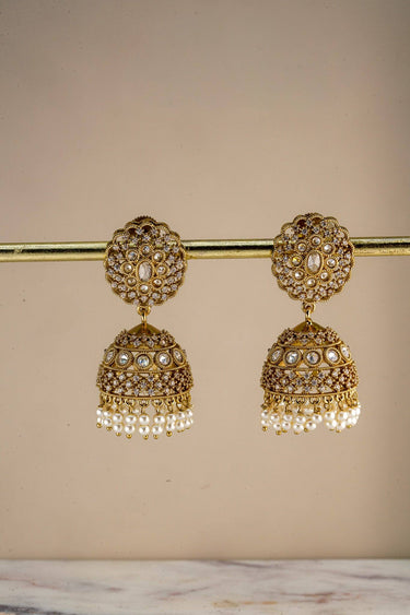 Pair of Inaury Nakshi Scallop Pearl White AD jhumka earrings on gold bar — ivory pearl drops and AD-studded filigree tops