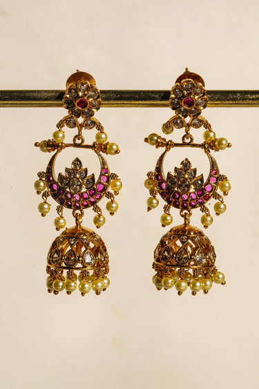 Inaury Saaira Kundan Chandbali Jhumka Earrings close-up on earring stand — gold-plated kundan earrings with ruby-pink stones, lotus motif, and pearl drops