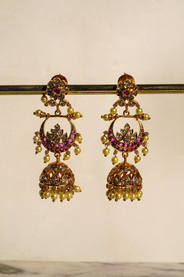 Inaury Saaira Kundan Chandbali Jhumka Earrings front view on earring stand — three-tier gold-plated kundan earrings with chandbali crescent and jhumka drop