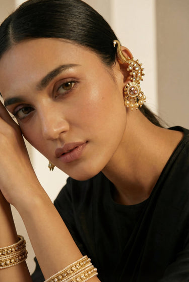 Model wearing Inaury Tripthi Ear Climbers Pearl White with gold bangles — handcrafted South Asian kundan peacock ear climber jewelry