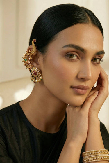Model wearing Inaury Tripthi Ear Climbers Ruby Emerald on both ears — gold-plated kundan statement ear climbers with peacock motif for Eid and wedding celebrations