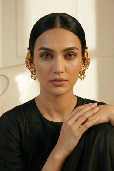Inaury Tripthi Ear Climbers in Ruby Emerald on model — gold-plated kundan peacock ear climbers with ruby and emerald stones for desi wedding jewelry