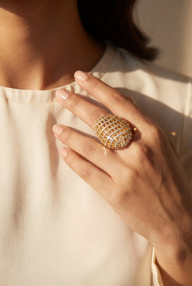 Yasna gold plated AD statement ring closeup on hand showing oversized pavé dome design Inaury