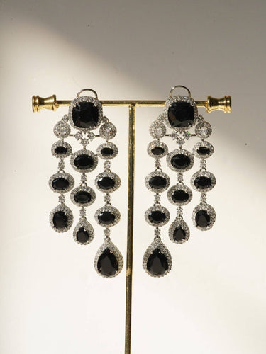 Jennie AD Chandelier Earrings in rhodium-plated silver, available in six colors: silver & emerald green, silver & turquoise, silver & sapphire blue, silver & maroon, silver & purple, silver & black, featuring asymmetrical design and AD stones.