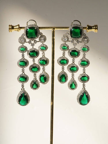 Jennie AD Chandelier Earrings in rhodium-plated silver, available in six colors: silver & emerald green, silver & turquoise, silver & sapphire blue, silver & maroon, silver & purple, silver & black, featuring asymmetrical design and AD stones.