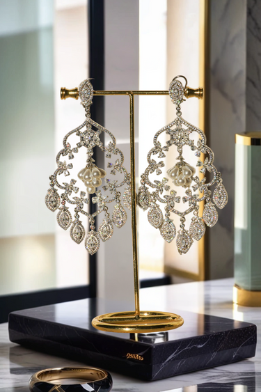 Julia Rhodium-Plated Statement Earrings with intricate detailing, 4.5-inch length, lightweight design, adorned with sparkling stones and pear-shaped dangles.