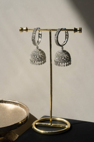 Rhodium plated Lailoma Jhumka Earrings on a stand