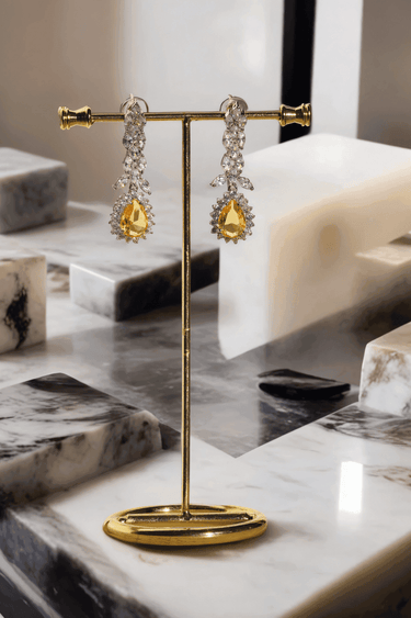 Lina Long Diamante Accent AD Necklace Set - Rhodium-plated with white AD stones, featuring intricate patterns and pendant-like centerpiece, available in silver & sapphire blue, silver & purple, and silver & citrine yellow, with matching dangling earrings.