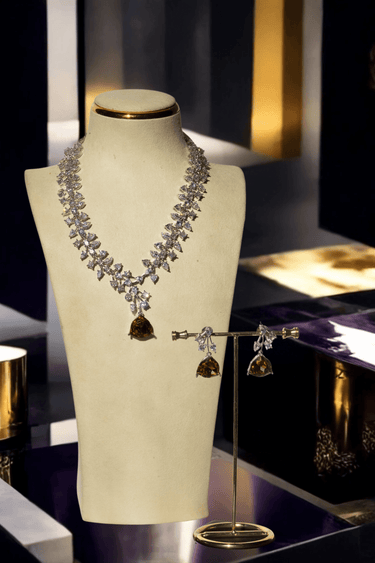 Mahnaz Diamante Lariat Necklace Set displayed on a stand