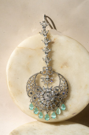 Rhodium-plated maang tikka with American Diamonds and mint green teardrop accents from Inaury