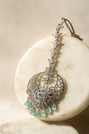 Rhodium-plated maang tikka with American Diamonds and mint green teardrop accents from Inaury