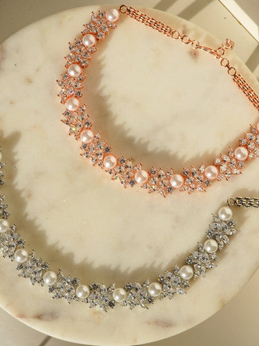 Mukta Diamante Accent AD Necklace Set - Rhodium or rose gold-plated finish, adorned with AD stones and faux pearls, featuring intricate floral patterns and matching minimal earrings.