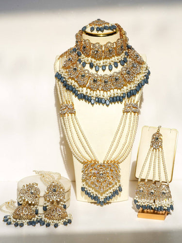 Nazanin Gold Plated Teal Bridal Set - 6-piece collection with gold plating, white zircon stones, teal blue beads, including jhumka earrings, choker, classic necklace, long necklace, jhoomer, and maang tikka.