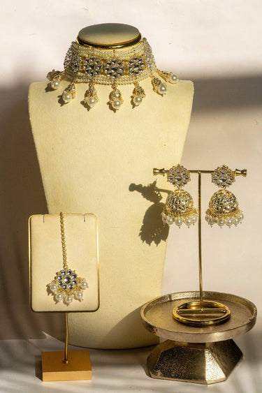 Neeshy champagne gold plated choker necklace set with resin bead detailing , paired with jhumka earrings and maang tikka from Inaury