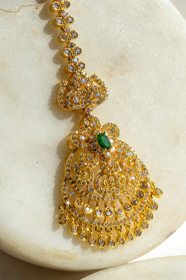 Gold and green maang tikka with American Diamond accents and teardrop dangles from Inaury.com