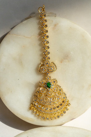 Gold and green maang tikka with American Diamond accents and teardrop dangles from Inaury.com