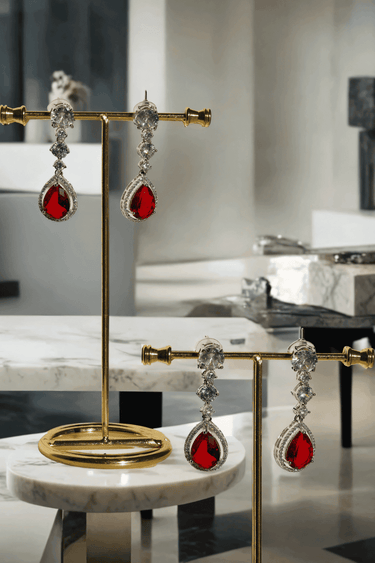 Nira Double Layered AD Necklace Set with criss-cross pattern, large teardrop pendant, and matching earrings in silver and mint green, silver and light pink, or silver and maroon.