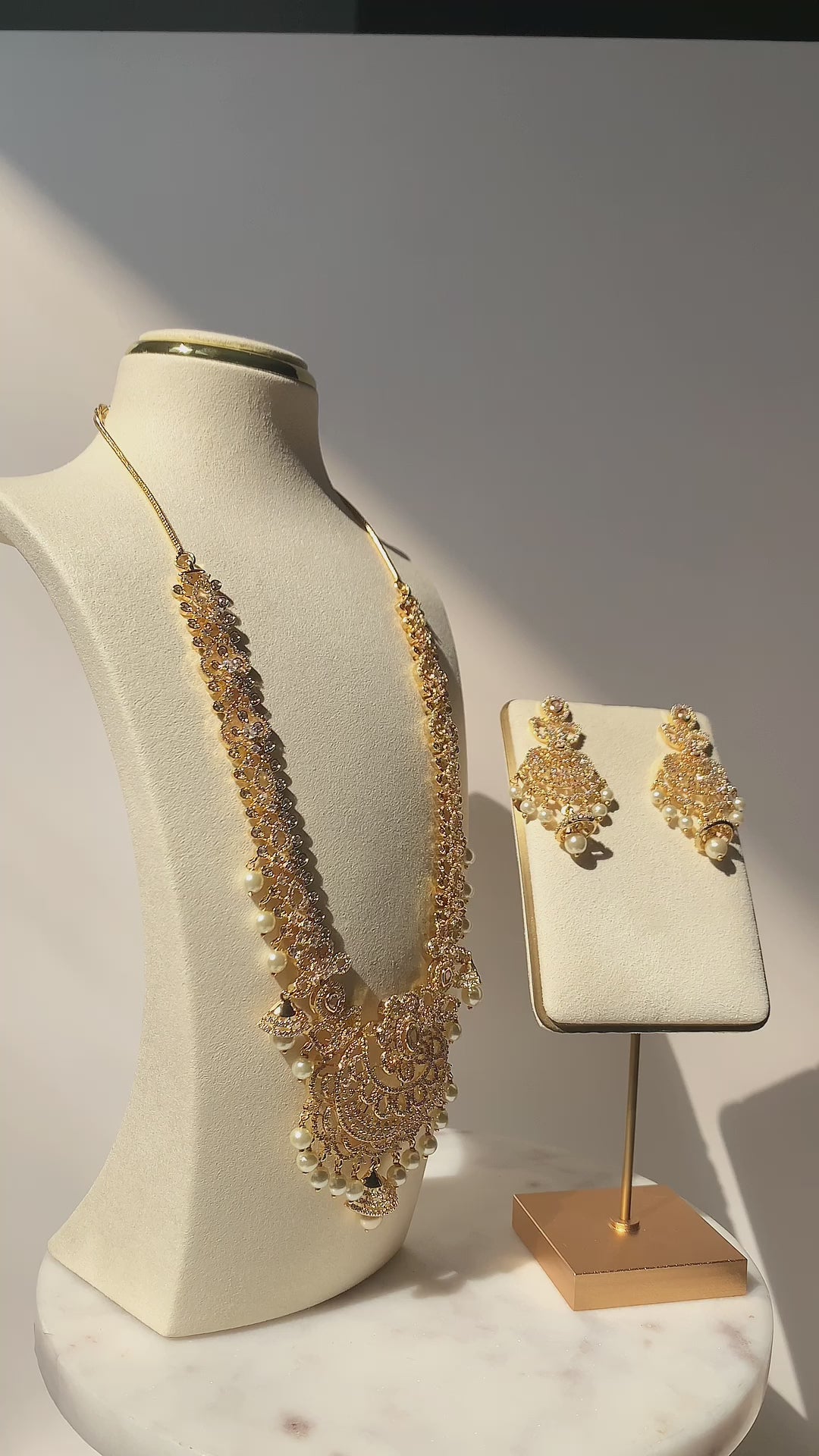 Anika - Gold CZ Long Necklace - Gold-plated necklace with paisley and floral setting designs, adorned with hanging pearls