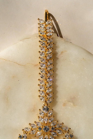 Reema maang tikka in gold with CZ stones and tear-drop accents from Inaury