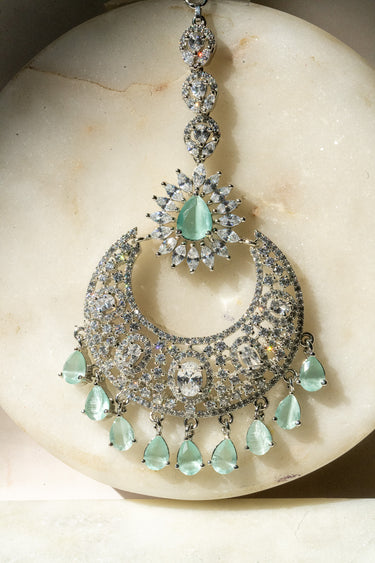 Rhodium-plated silver and mint green maang tikka with American Diamond stones in pink, ruby, mint green, and white from Inaury