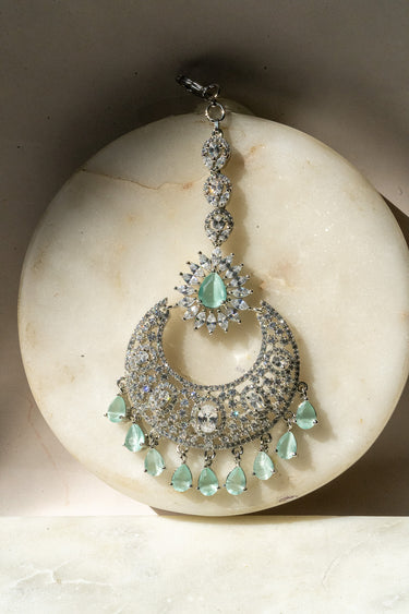 Rhodium-plated silver and mint green maang tikka with American Diamond stones in pink, ruby, mint green, and white from Inaury