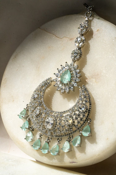 Rhodium-plated silver and mint green maang tikka with American Diamond stones in pink, ruby, mint green, and white from Inaury