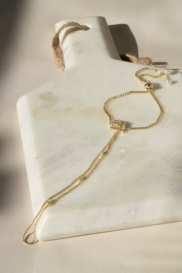 Soraya hand chain bracelet in gold plating with cubic stones