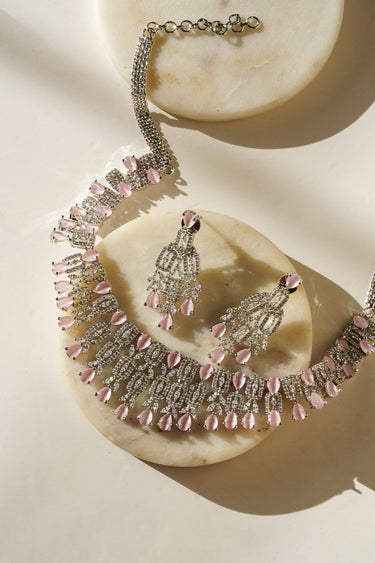 Aagya AD Necklace Set – Rhodium Plated in pink, laid out with earrings on marble, ideal for bridal or festive wear.