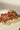 Side view of Arushi Pearl Choker showcasing pink stones, gold floral design, and pearl embellishments.