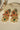 Pair of Arushi earrings with green Navratan stones, floral gold design, and pearl accents from the choker set.