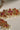 Close-up of pink Navratan stone Arushi choker with pearl fringe and intricate gold detailing.