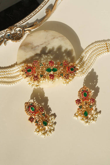 Traditional Arushi Pearl Choker Set with green stones and layered pearl strands, perfect for festive occasions.