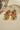 Green stone Arushi earrings with floral gold design and pearl drops, ideal for traditional outfits.