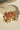 Pair of Arushi earrings with pink and green stones, floral gold design, and pearl accents.