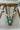 Close-up of Chahat Necklace pendant in green. Rhodium-plated floral design with teardrop and marquise stones.
