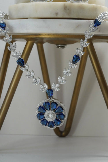 Close-up of Chahat Necklace floral pendant in blue. Rhodium-plated with teardrop and marquise-cut AD stones.