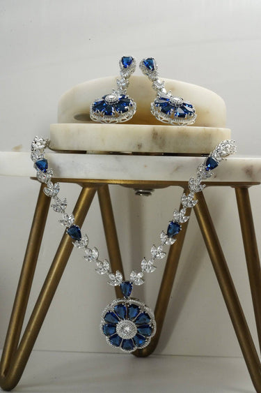 Chahat Necklace Set - Rhodium Floral AD in blue with matching earrings. Classic design with shimmering AD stones.