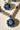 Close-up of Chahat Necklace Set - Rhodium Floral AD in blue. Features intricate floral pendant with sparkling AD stones.
