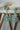 Chahat Floral AD Earrings in mint green. Rhodium-plated with floral-cut stones and teardrop tops.