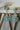 Chahat Floral AD Earrings in mint green. Rhodium-plated with floral-cut stones and teardrop tops.