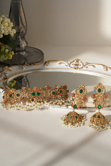 Chaya Navratan choker necklace with green stones and pearl fringe, styled for traditional South Asian weddings and events.