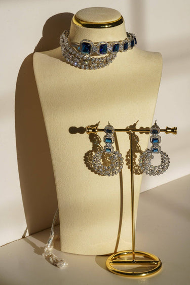 Mahi Asymmetrical Choker Necklace Set - Rhodium-plated with AD stones, available in silver & green, silver & ruby, and silver & sapphire blue, perfect for contemporary elegance.