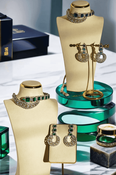 Mahi Asymmetrical Choker Necklace Set - Rhodium-plated with AD stones, available in silver & green, silver & ruby, and silver & sapphire blue, perfect for contemporary elegance.