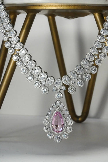 Close-up of Mirah AD Necklace Set - Elegant Jewelry featuring pink teardrop pendant and intricate CZ detailing on silver base.