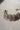 Side view of lavender beaded choker from Namar Silver Plated AD Indian Choker Necklace Set on marble base.