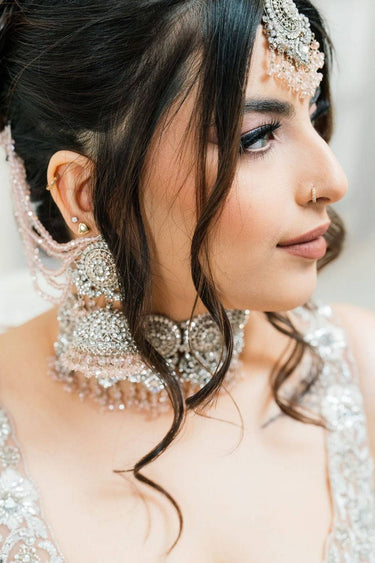 Side profile of model showcasing Namar Silver Plated AD Indian Choker Necklace Set with detailed earrings and maang tikka.