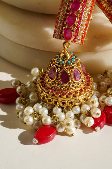 Navdeep Jhumka Earrings - Handcrafted with antique gold plating, available in ruby, blue, or gold, featuring multi-color stones and embellishments.