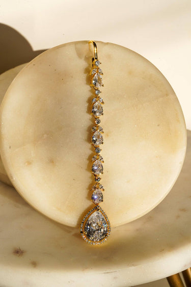 Nila Diamanté Accent Golden AD Maang Tikka - Gold-plated with teardrop stones and diamante accents, available in gold & multicolor or gold & white.